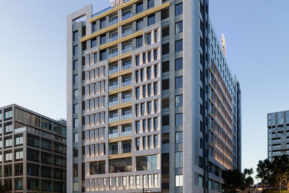 Render of the Al Zain View tower at dusk: stone facade with gold bands above a row of trees on Grand Mosque Street.